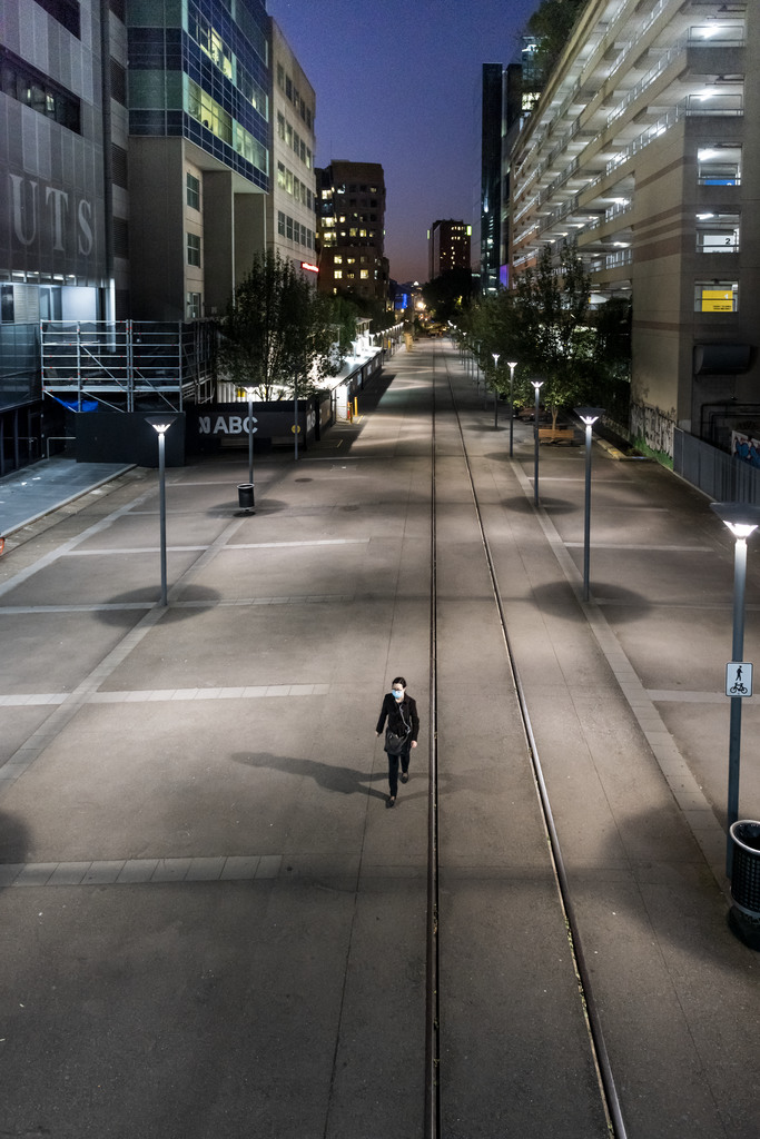 Item 01: A solitary woman wearing a medical mask walks down the Goods Line in Ultimo during a usually busy peak hour at the height of COVID-19 lockdown, Sydney, New South Wales, 14 April 2020 / photograph by John Janson-Moore