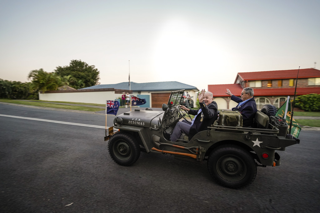 Item 06: Veterans drive around the streets of Tweed Heads waving at those commemorating Anzac Day during the Coronavirus (COVID-19) pandemic, Pioneer Parade, Banora Point, New South Wales, 25 April 2020