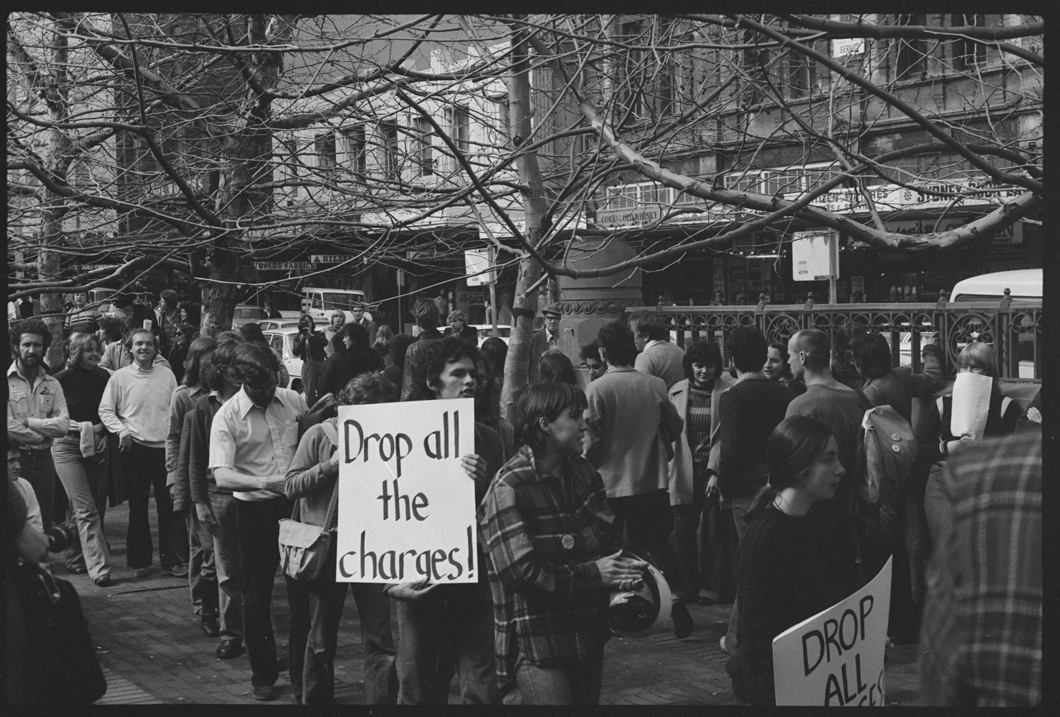 Placard: ‘Drop All the Charges’, protest outside Central Police Court, Liverpool St, Sydney. Tribune Collection